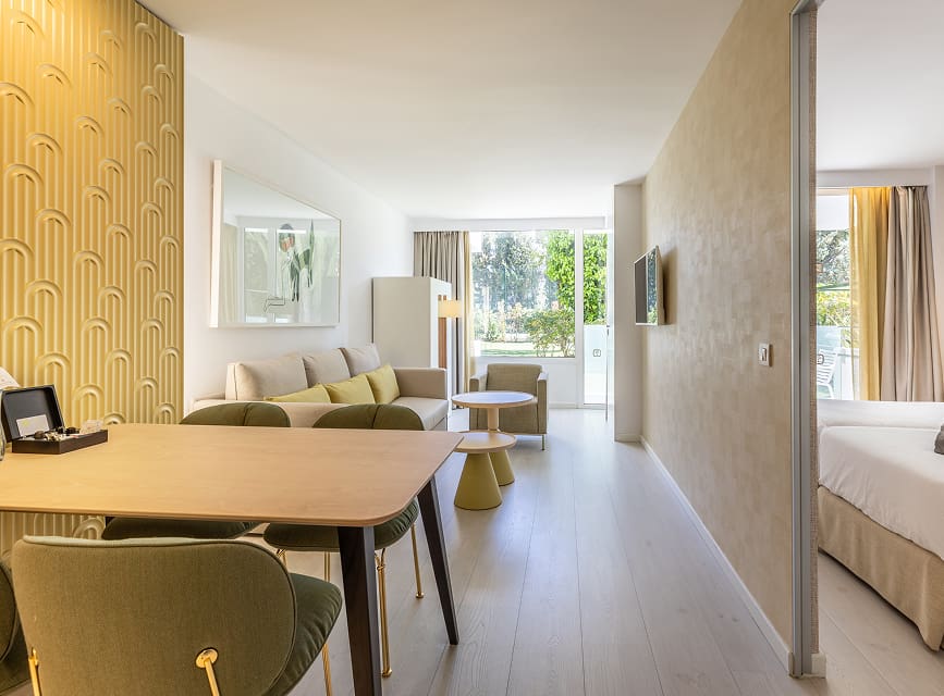 Living and dining room at Illa d'Or Apartments Bright living and dining room with table, sofa and seating area next to the bedroom, in a Puerto Pollensa apartment