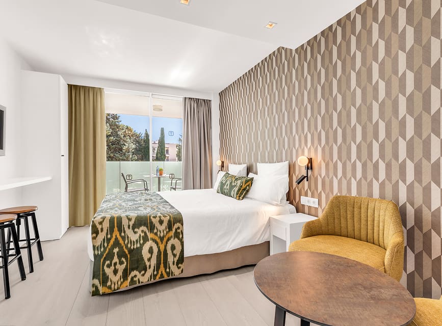 Studio with double bed in Puerto Pollensa Studio with double bed, traditional Mallorcan fabric bedspread, yellow armchair and terrace access