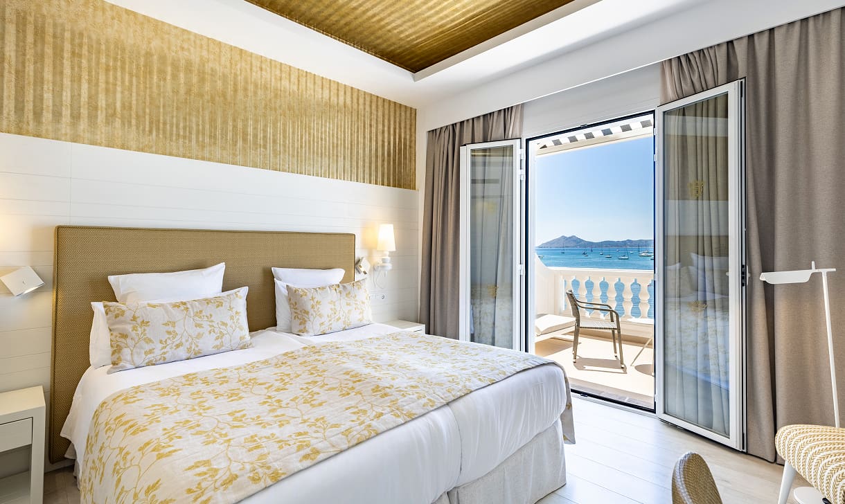Zimmer mit zwei Einzelbetten und offenen Türen zur Terrasse mit Blick auf das Mittelmeer