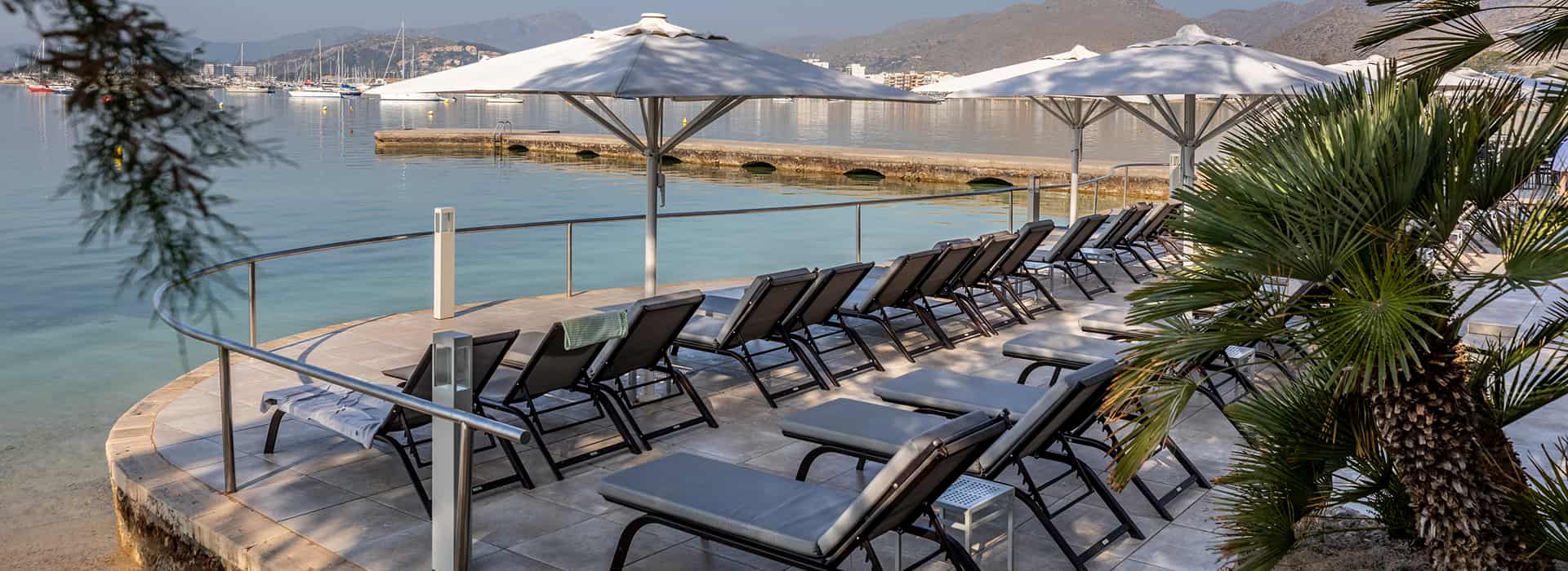 Hotel Illa d'Or | Sun Terrace Sun loungers facing the sea on the Puerto Pollensa seafront promenade, on the grounds of the Hotel Illa d'Or
