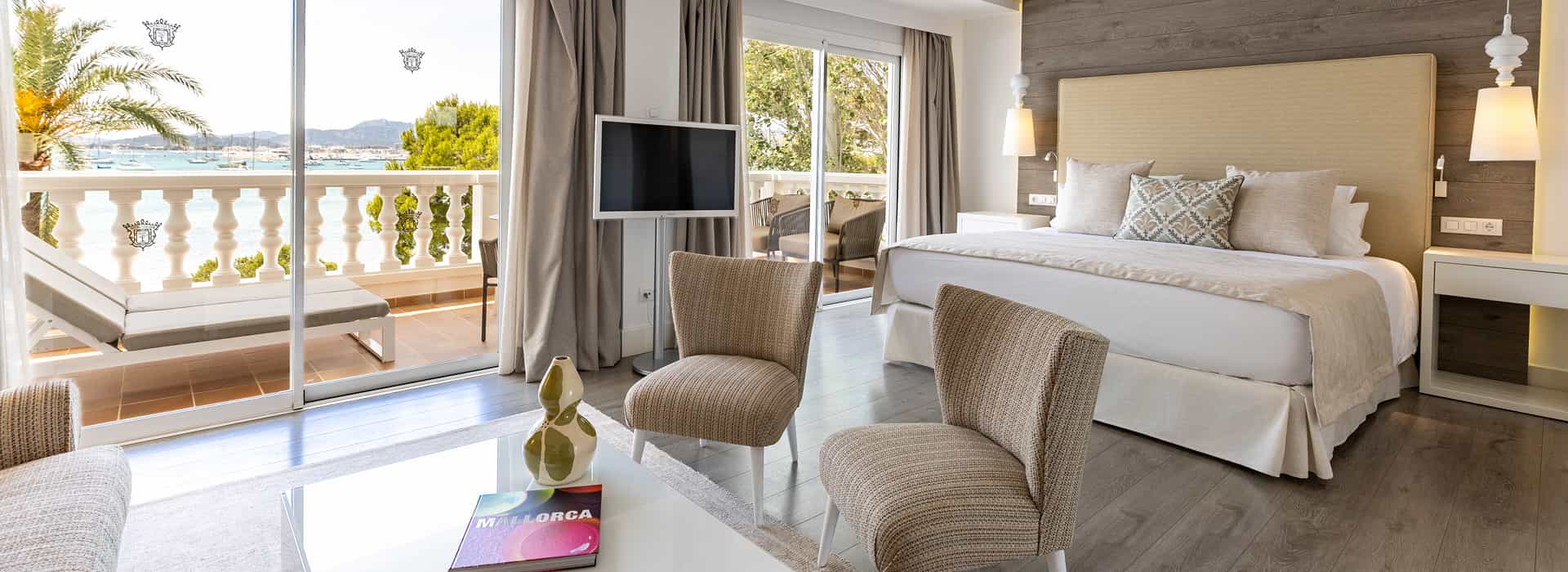 Hotel Illa d'Or | Sea-view room A spacious room decorated in shades of gold, with a terrace featuring sun loungers and sea views